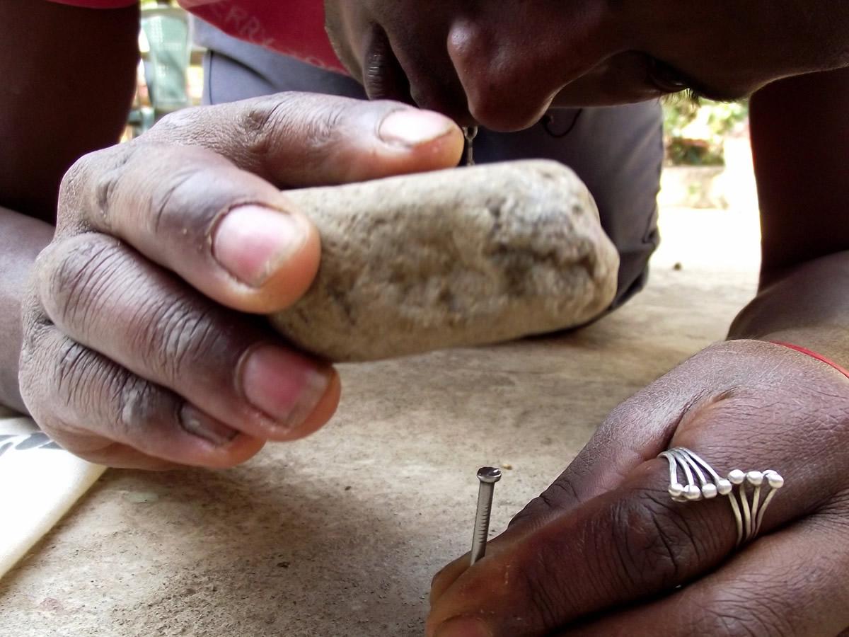 hammering a nail with a stone
